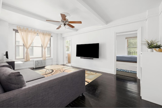 325 W 45th St Unit 312, New York City, NY 10036 - living area featuring radiator heating unit, ceiling fan, wood finished floors, and beamed ceiling