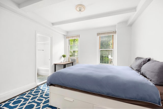 325 W 45th St Unit 312, New York City, NY 10036 - bedroom featuring beam ceiling, connected bathroom, and cooling unit