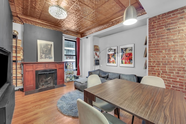 255 W 95th St Unit 4D, New York City, NY 10025 - dining space with an ornate ceiling, light wood-style floors, and a fireplace with flush hearth