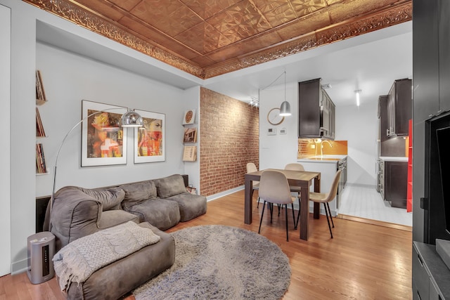255 W 95th St Unit 4D, New York City, NY 10025 - living area with an ornate ceiling, a tray ceiling, light wood-style flooring, and brick wall
