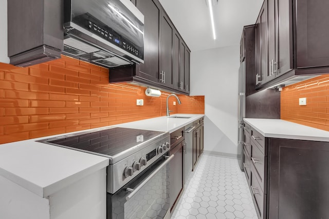 255 W 95th St Unit 4D, New York City, NY 10025 - kitchen with appliances with stainless steel finishes, decorative backsplash, light countertops, dark brown cabinetry, and light tile patterned flooring