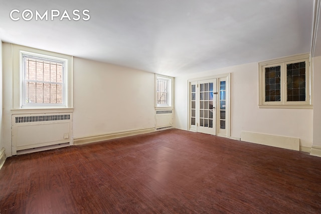 1387 Union St, New York City, NY 11213 - spare room with radiator heating unit, healthy amount of natural light, and wood finished floors