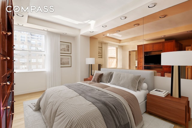 71 Park Ave Unit 12A, New York City, NY 10016 - bedroom featuring a tray ceiling, recessed lighting, and light wood-style floors