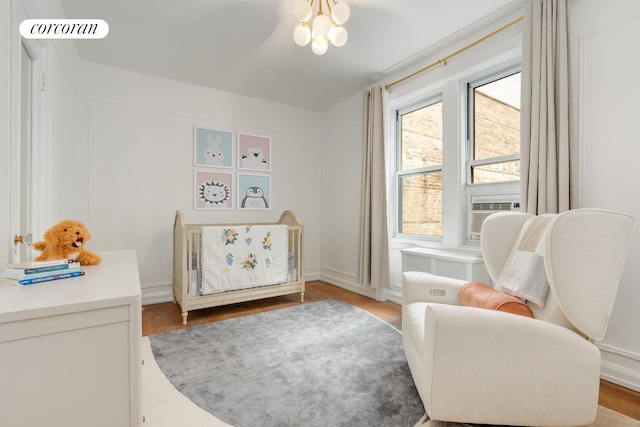 128 Willow St Unit 4F, New York City, NY 11201 - bedroom with wood finished floors, cooling unit, and a chandelier