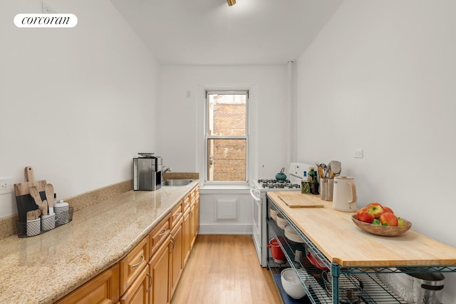 128 Willow St Unit 4F, New York City, NY 11201 - kitchen featuring gas range gas stove, light wood finished floors, and light stone counters