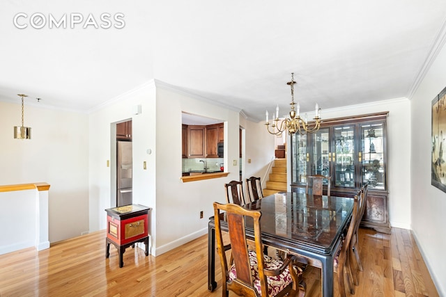 436 78th St Unit 5, New York City, NY 11209 - dining space featuring a chandelier, light wood-style floors, and ornamental molding