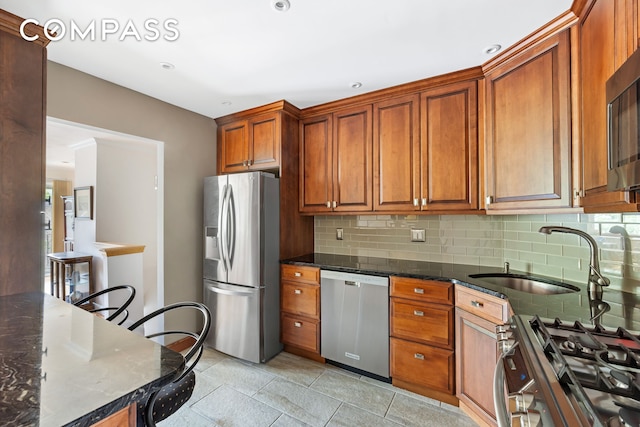 436 78th St Unit 5, New York City, NY 11209 - kitchen with stainless steel appliances, backsplash, light tile patterned floors, and dark stone counters
