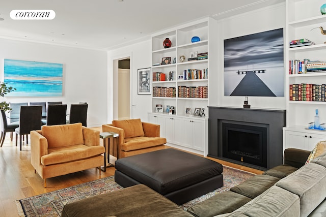7 Harrison St Unit 4S, New York City, NY 10013 - living room with wood-type flooring, crown molding, a fireplace, and built in shelves
