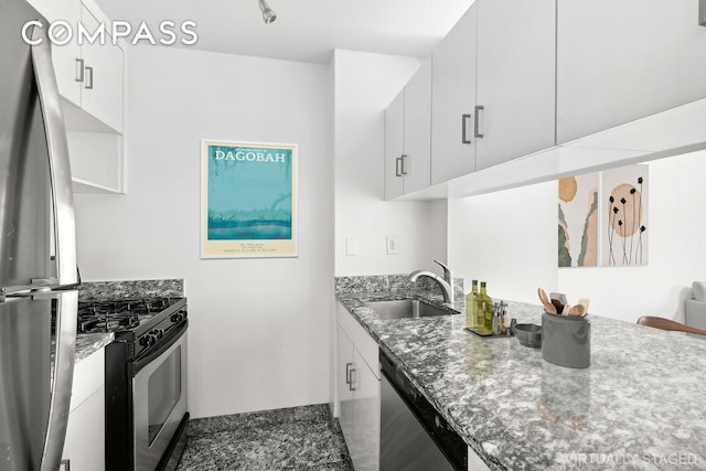 1 Irving Pl Unit U10C, New York City, NY 10003 - kitchen with stainless steel appliances, stone counters, and white cabinets