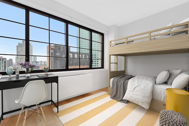 27-21 44th Dr Unit 1601, New York City, NY 11101 - bedroom with light wood-style floors, multiple windows, and a view of city