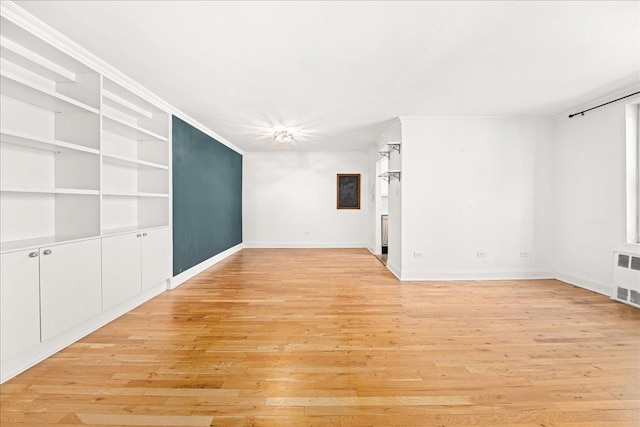 309 E 87th St Unit 7-J, New York City, NY 10128 - unfurnished room featuring light wood-style flooring, ornamental molding, radiator heating unit, and built in features