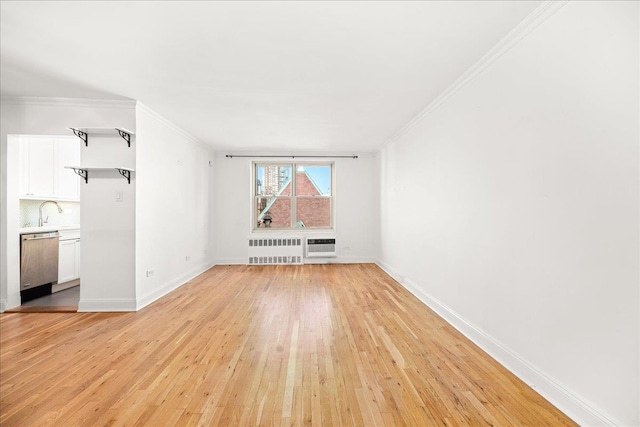 309 E 87th St Unit 7-J, New York City, NY 10128 - unfurnished living room with radiator heating unit, ornamental molding, and light wood finished floors