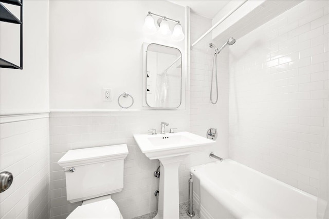 309 E 87th St Unit 7-J, New York City, NY 10128 - bathroom with bathtub / shower combination, a wainscoted wall, tile walls, and pet washing area