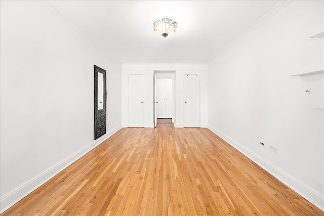 309 E 87th St Unit 7-J, New York City, NY 10128 - unfurnished room with light wood-style floors and ornamental molding
