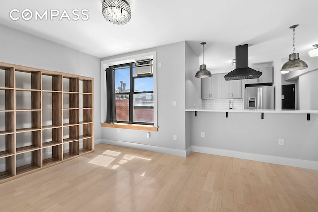 108 Division Ave Unit 22, New York City, NY 11211 - unfurnished living room featuring light wood finished floors and a chandelier