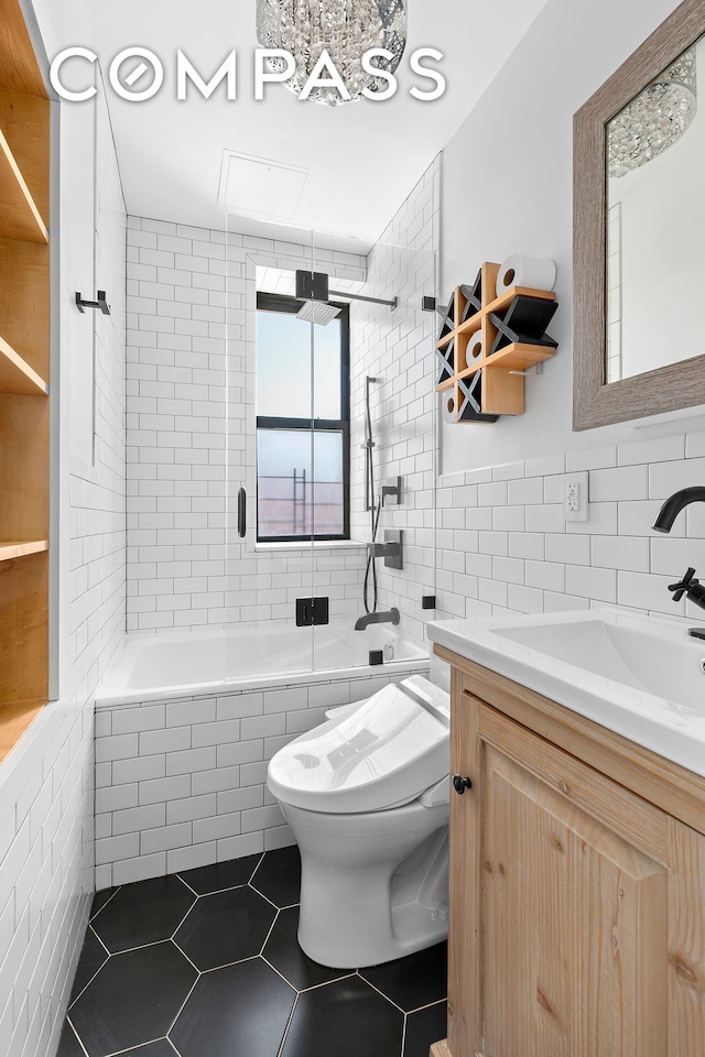 108 Division Ave Unit 22, New York City, NY 11211 - full bath with tile walls, tile patterned floors, tiled shower / bath combo, and vanity