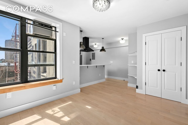 108 Division Ave Unit 22, New York City, NY 11211 - unfurnished living room with wood finished floors, a view of city, and a chandelier