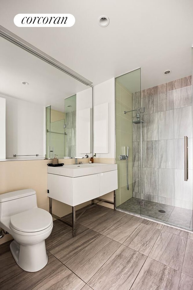 388 Bridge St Unit 35Ab, New York City, NY 11201 - bathroom with a stall shower, vanity, wood finished floors, and recessed lighting