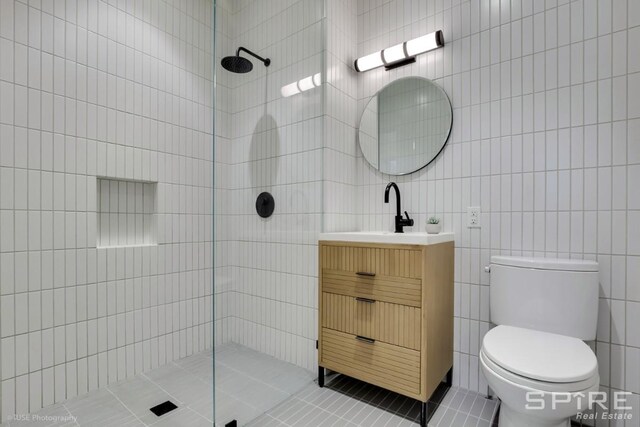 111 Montgomery St Unit 1N, New York City, NY 11225 - bathroom featuring tile walls, a walk in shower, vanity, and tile patterned flooring