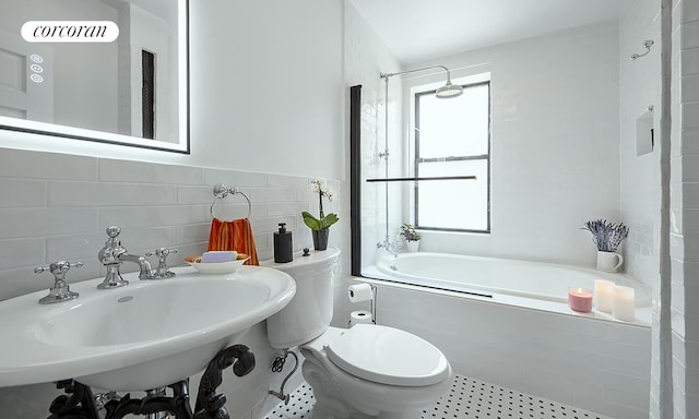 333 E 80th St Unit 3G, New York City, NY 10075 - bathroom featuring tile walls,  shower combination, and tile patterned flooring