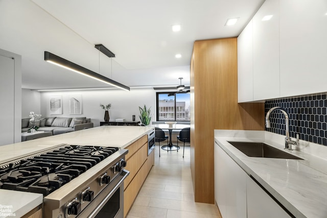 201 W 70th St Unit 24B, New York City, NY 10023 - kitchen featuring modern cabinets, appliances with stainless steel finishes, light stone counters, white cabinetry, and recessed lighting