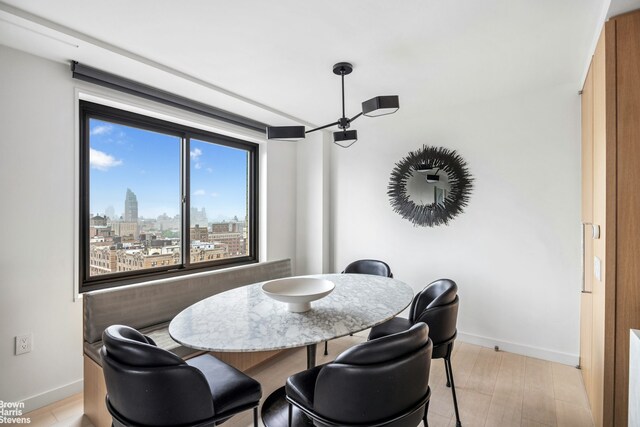201 W 70th St Unit 24B, New York City, NY 10023 - dining room featuring baseboards and a skyline view