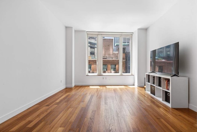 15 William St Unit 9C, New York City, NY 10004 - unfurnished living room featuring wood finished floors