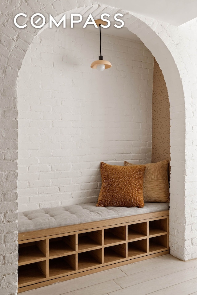252 Greene Ave Unit 1B, New York City, NY 11238 - mudroom featuring brick wall, wood finished floors, and arched walkways