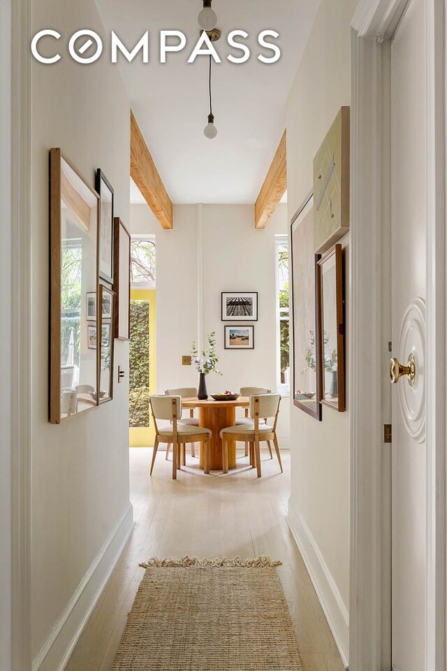 252 Greene Ave Unit 1B, New York City, NY 11238 - hallway featuring beamed ceiling, healthy amount of natural light, and light wood-style flooring