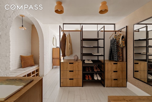 252 Greene Ave Unit 1B, New York City, NY 11238 - walk in closet featuring light wood-type flooring and arched walkways