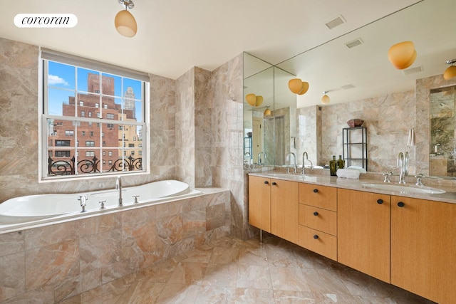 28 E 70th St Unit Ph1, New York City, NY 10021 - bathroom with tile walls, double vanity, a bath, and marble finish flooring