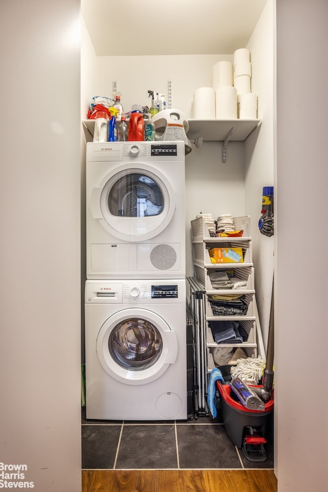 515 E 72nd St Unit 5F, New York City, NY 10021 - laundry area featuring stacked washer / drying machine and wood finished floors