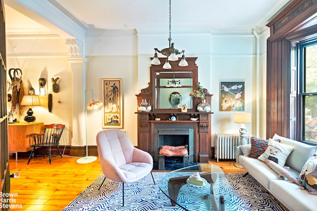 744 Carroll St, New York City, NY 11215 - living room featuring radiator, hardwood / wood-style flooring, crown molding, and a fireplace with flush hearth