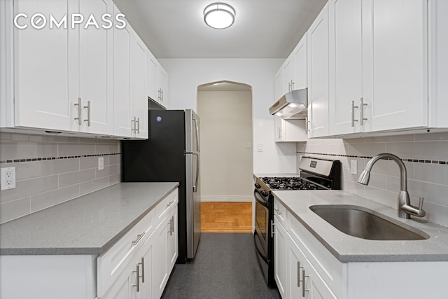 41-09 41st St Unit 2B, New York City, NY 11104 - kitchen featuring appliances with stainless steel finishes, under cabinet range hood, arched walkways, and tasteful backsplash