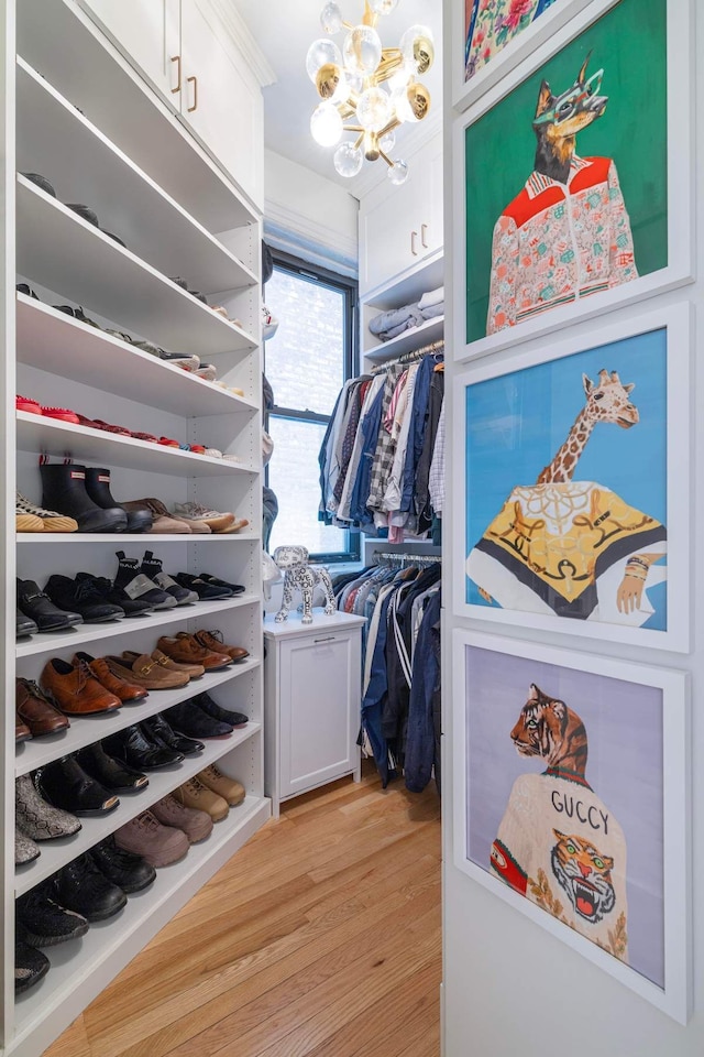 350 W 48th St Unit 4E, New York City, NY 10036 - spacious closet featuring a chandelier and light wood-style floors