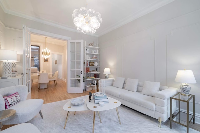 350 W 48th St Unit 4E, New York City, NY 10036 - living area featuring a chandelier, crown molding, french doors, and light wood-style floors