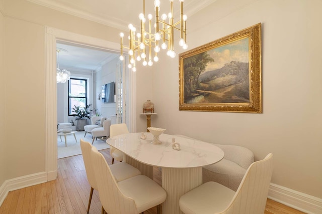 350 W 48th St Unit 4E, New York City, NY 10036 - dining space featuring ornamental molding, a chandelier, and hardwood / wood-style flooring