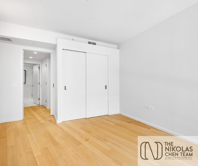 425 W 53rd St Unit 205, New York City, NY 10019 - unfurnished bedroom featuring light wood-style flooring, a closet, and recessed lighting
