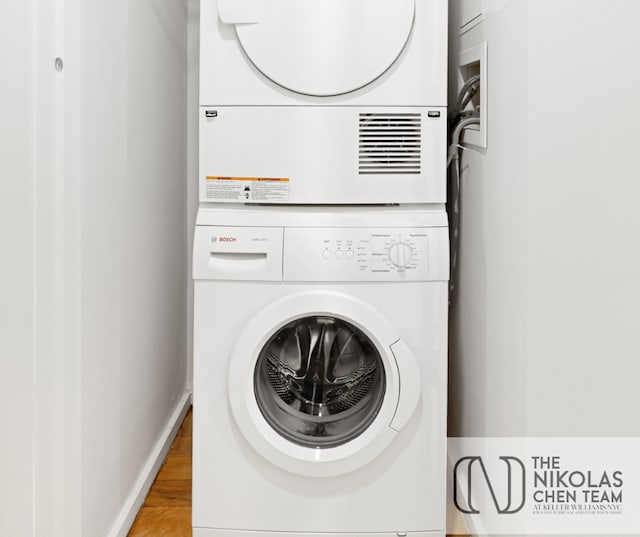 425 W 53rd St Unit 205, New York City, NY 10019 - laundry area featuring stacked washer / dryer and light wood-style flooring