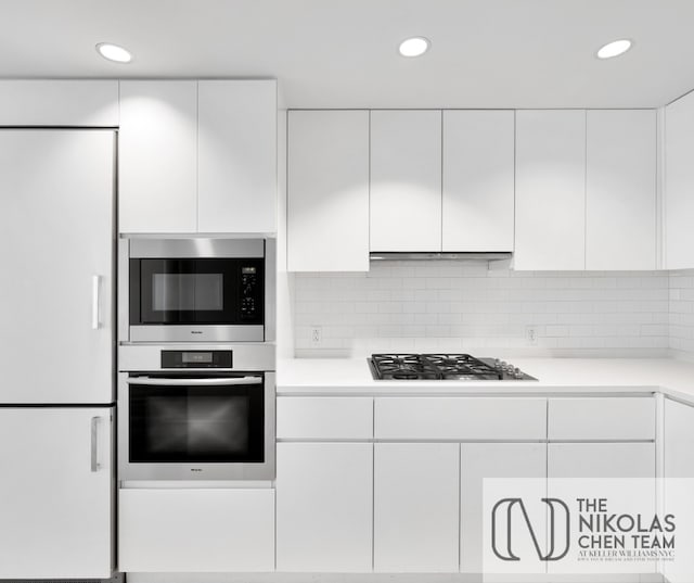425 W 53rd St Unit 205, New York City, NY 10019 - kitchen with appliances with stainless steel finishes, white cabinets, light countertops, recessed lighting, and modern cabinets