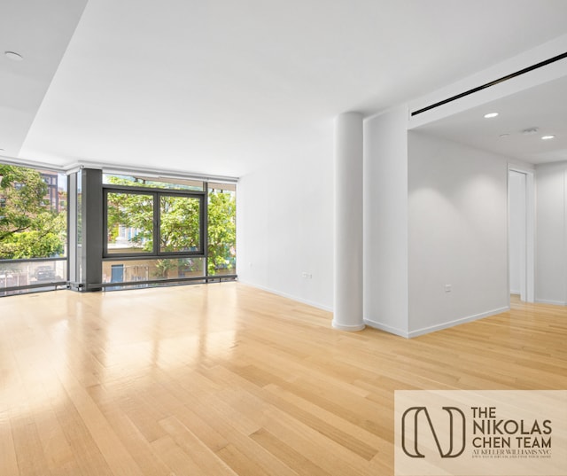 425 W 53rd St Unit 205, New York City, NY 10019 - unfurnished room with a wall of windows and wood finished floors