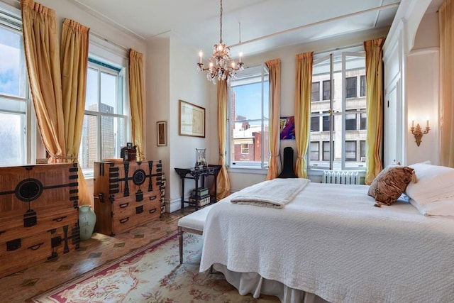 684 Broadway Unit 4E, New York City, NY 10012 - bedroom with a chandelier, radiator, and wood finished floors