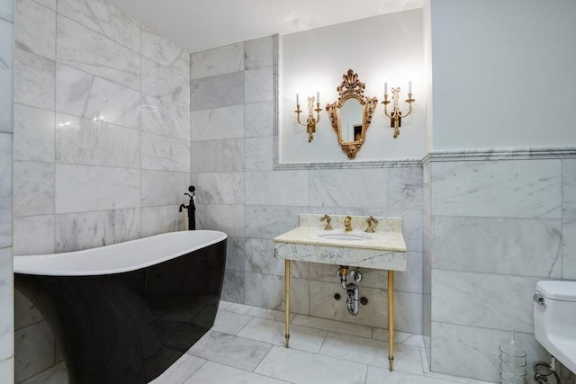 684 Broadway Unit 4E, New York City, NY 10012 - full bathroom featuring tile walls, a soaking tub, and tile patterned flooring