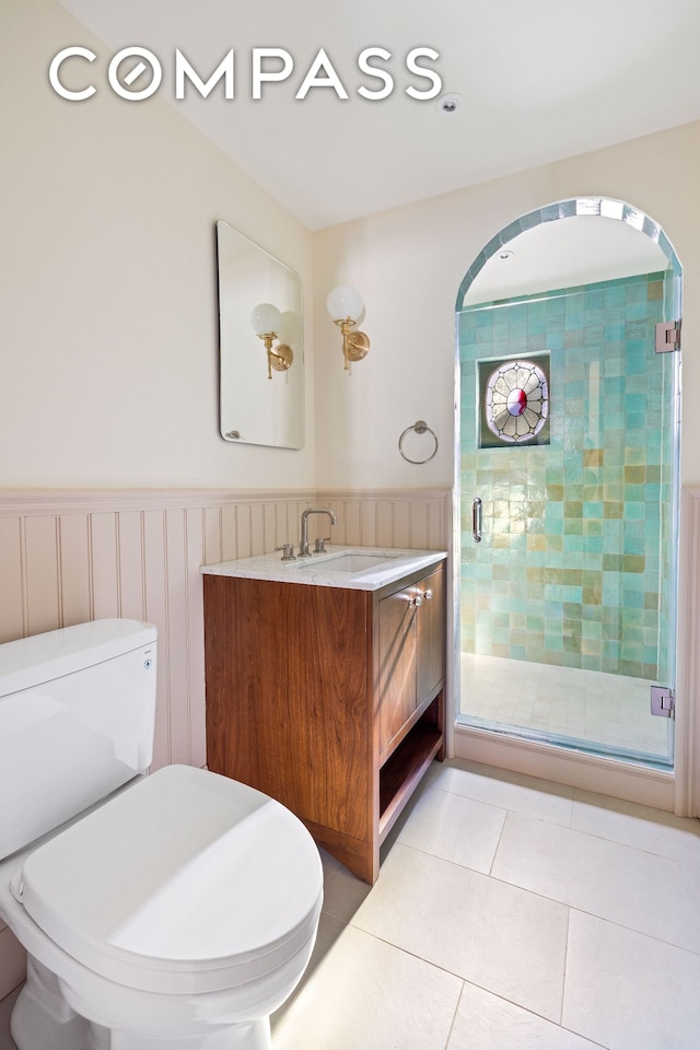 320 E 18th St Unit 5, New York City, NY 11226 - full bathroom featuring vanity, a shower stall, tile patterned floors, and wainscoting