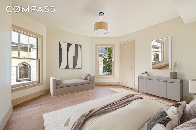 320 E 18th St Unit 5, New York City, NY 11226 - bedroom with multiple windows and light wood-type flooring