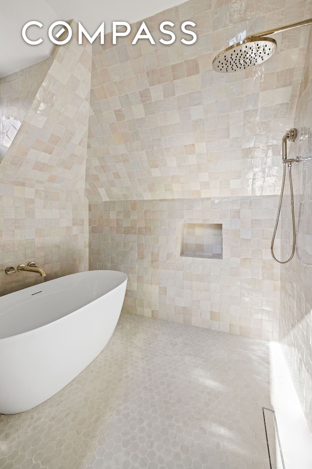 320 E 18th St Unit 5, New York City, NY 11226 - full bathroom with a freestanding tub, tiled shower, and tile walls
