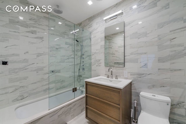 124 E 13th St Unit 3, New York City, NY 10003 - bathroom featuring a combined bath / shower with rainfall shower, tile walls, and vanity