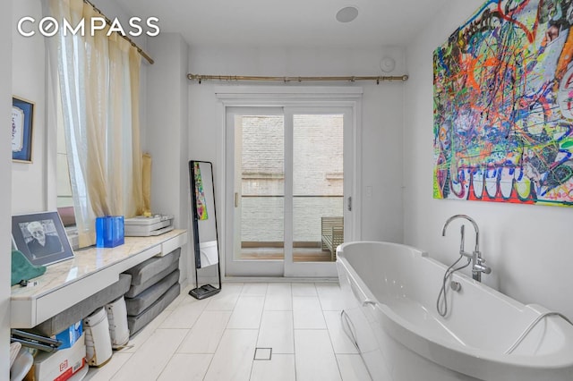 124 E 13th St Unit 3, New York City, NY 10003 - bathroom featuring a soaking tub and tile patterned floors