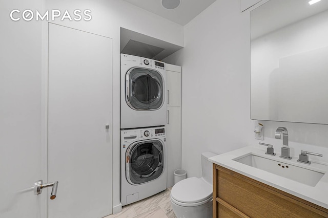 124 E 13th St Unit 3, New York City, NY 10003 - bathroom featuring stacked washer and clothes dryer, vanity, and marble look tiles