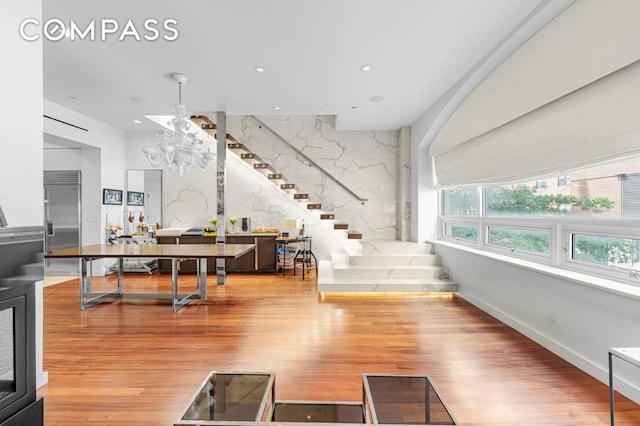 124 E 13th St Unit 3, New York City, NY 10003 - living area with a chandelier, wood finished floors, and stairway